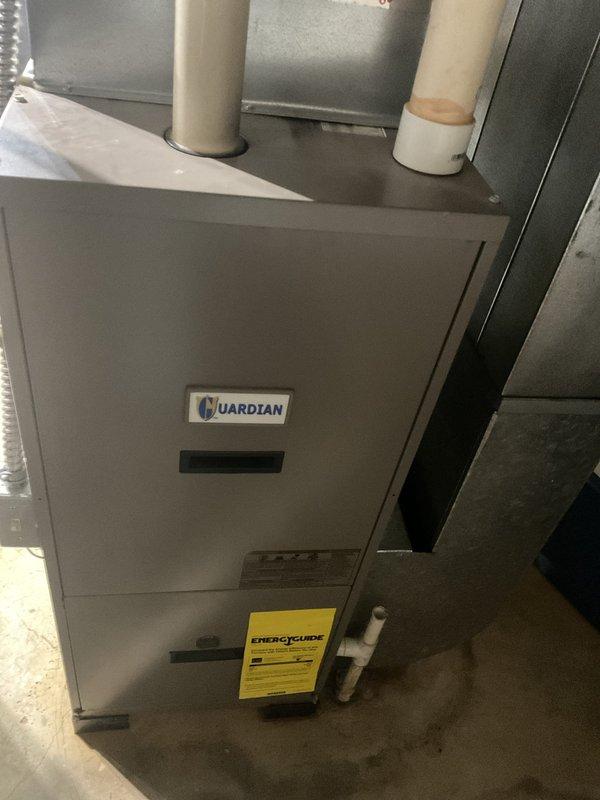 Performed on-site assessment of existing Guardian brand residential furnace system and electrical service panel to provide air conditioning replacement estimate. Documented current HVAC equipment configuration, including furnace unit specifications, venting arrangement with PVC piping, and electrical panel circuit allocation showing dedicated furnace breaker, to determine compatibility requirements and installation parameters for proposed AC system upgrade.
