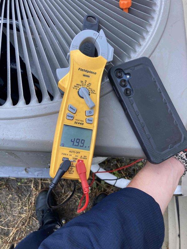 Completed prepaid AC tune-up maintenance on residential air conditioning system with no reported issues. Performed comprehensive system inspection including control board evaluation and electrical diagnostics, measuring 499 reading on clamp meter at outdoor condenser unit. Inspected circuit board connections, wiring harnesses, and all electronic components for proper operation and wear.