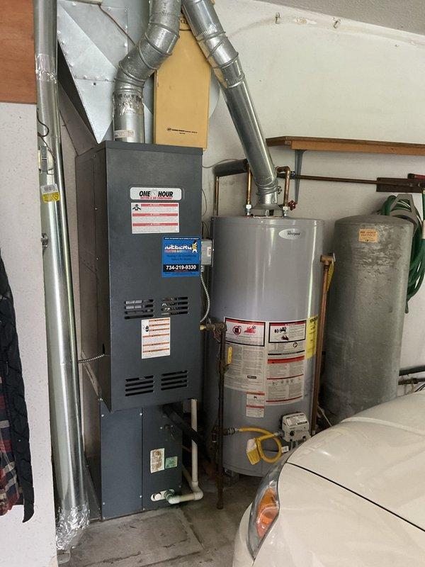 Conducted comprehensive on-site evaluation for complete HVAC system replacement. Assessed existing furnace unit and associated ductwork configuration in residential utility space. Documented current equipment specifications, installation layout, and mechanical room accessibility for new system design. Photographed existing furnace with vertical configuration, metallic ductwork routing, water heater placement, and utility room clearances to determine optimal replacement equipment sizing and installation requirements. Provided detailed estimate for new HVAC system installation based on space constraints and existing infrastructure.