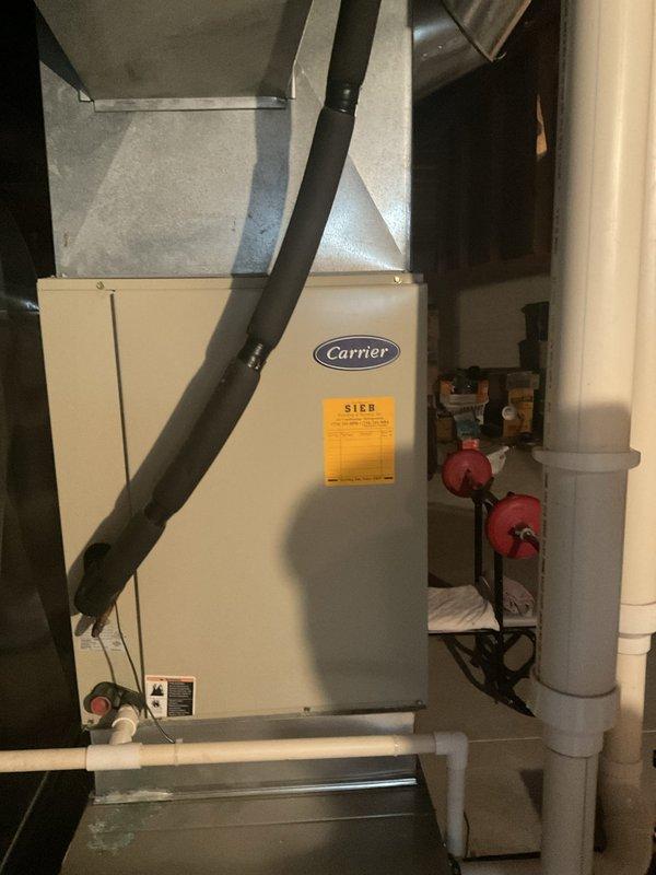 Conducted comprehensive diagnostic evaluation of R-22 residential air conditioning system experiencing multiple component failures. Inspection revealed failed condenser fan motor, failed compressor, degraded capacitor with visible bulging indicating imminent failure, and worn contactor exhibiting pitting and chattering during operation. Due to the extent of component failures, refrigerant charge could not be properly assessed. Documented existing Carrier HVAC system configuration including air handler installation with associated ductwork, condensate drainage system, and outdoor condensing unit. Provided detailed photographic documentation of current equipment condition and system layout for replacement estimate purposes.