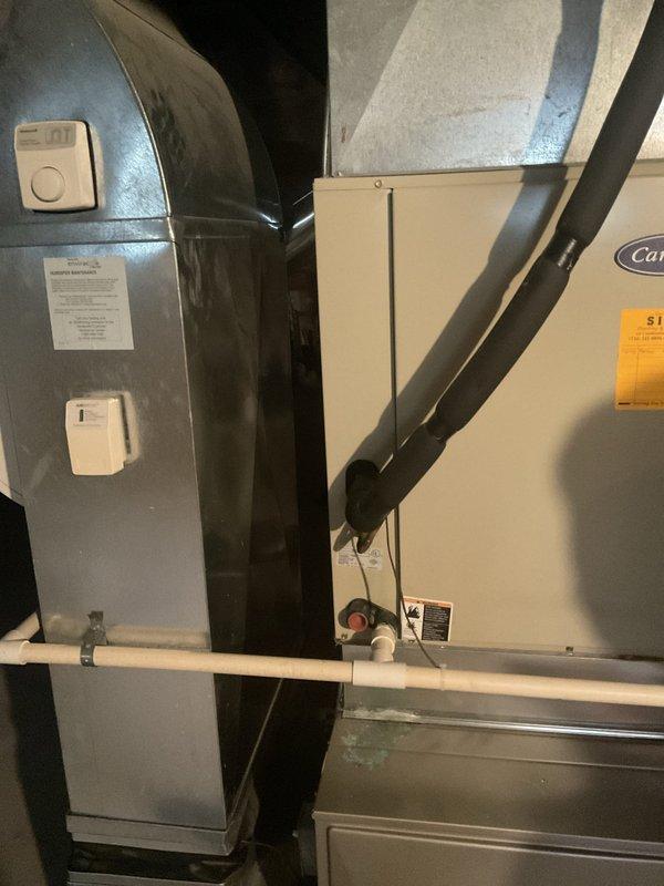 Conducted comprehensive diagnostic evaluation of R-22 residential air conditioning system experiencing multiple component failures. Inspection revealed failed condenser fan motor, failed compressor, degraded capacitor with visible bulging indicating imminent failure, and worn contactor exhibiting pitting and chattering during operation. Due to the extent of component failures, refrigerant charge could not be properly assessed. Documented existing Carrier HVAC system configuration including air handler installation with associated ductwork, condensate drainage system, and outdoor condensing unit. Provided detailed photographic documentation of current equipment condition and system layout for replacement estimate purposes.