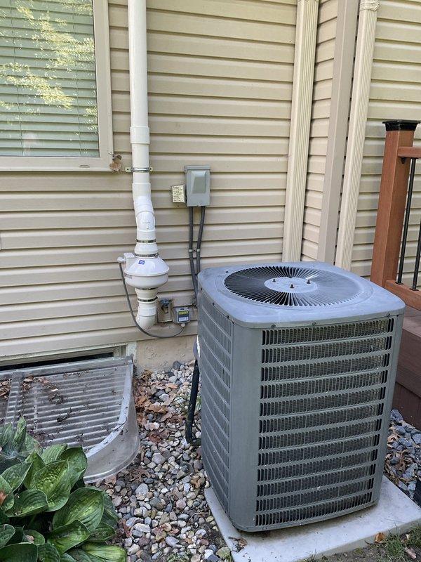 Conducted on-site evaluation of residential HVAC system installed in 2004, consisting of R-22 air conditioning unit and furnace. System assessment revealed low refrigerant charge in the air conditioning condenser unit. Documented existing equipment conditions through photographic records showing outdoor condenser unit mounted on concrete pad with proper electrical disconnect, condensate drainage system, and standard utility connections. Provided comprehensive replacement estimate for aging HVAC system due to obsolete R-22 refrigerant and equipment age approaching end of serviceable life expectancy.