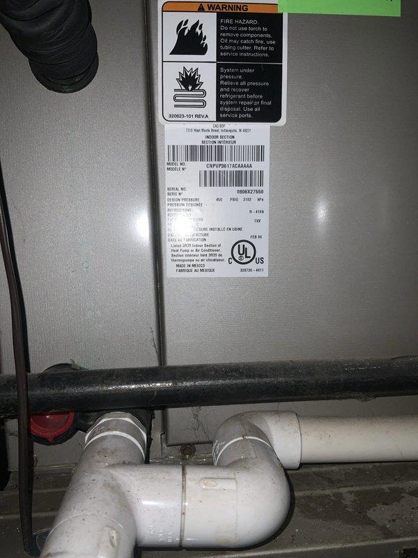 Responded to no cooling complaint on aging HVAC system. Upon inspection, documented equipment nameplate specifications and condenser fan motor assembly condition. Unit showed signs of age-related wear consistent with 10+ year operation, requiring further diagnostic evaluation to determine root cause of cooling failure.