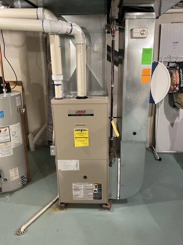 Provided comprehensive estimate for complete HVAC system replacement including furnace, air handler, and humidifier for 24-year-old existing equipment currently located in basement mechanical room. Assessed existing Lennox gas furnace installation with associated ductwork, PVC venting, and condensate drainage system, as well as attic-mounted air handler with flex duct connections. Recommended full system upgrade to improve efficiency and reliability given age of current equipment, with humidifier integration to be included in replacement scope.