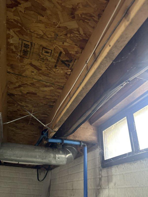 Installed ground fault circuit interrupter (GFI) protection in basement utility area. Work included mounting electrical components to concrete block wall near existing panel box, running conduit and wiring through exposed ceiling joists, and ensuring proper grounding and code compliance for moisture-prone environment adjacent to plumbing infrastructure and mechanical systems.