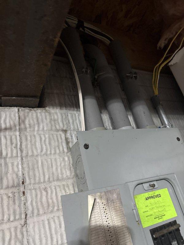 Installed ground fault circuit interrupter (GFI) protection in basement utility area. Work included mounting electrical components to concrete block wall near existing panel box, running conduit and wiring through exposed ceiling joists, and ensuring proper grounding and code compliance for moisture-prone environment adjacent to plumbing infrastructure and mechanical systems.