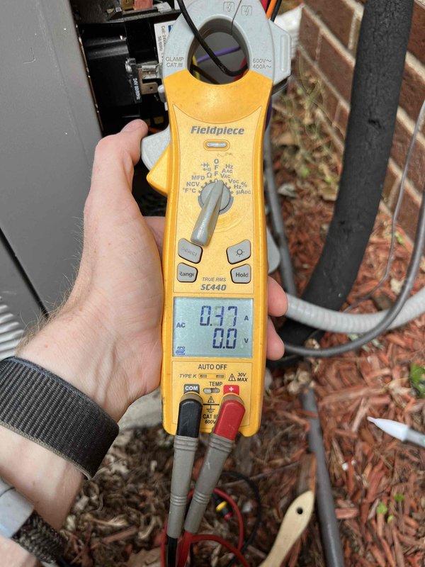 Completed Club AC12-4 preventive maintenance agreement visit on air conditioning system. Performed electrical diagnostics using digital multimeter, measuring voltage at 35.66V on system components and verifying current draw at 0.97A at the outdoor unit electrical panel. Inspected condenser unit wiring connections, contactors, and relays to ensure proper operation and electrical safety compliance.