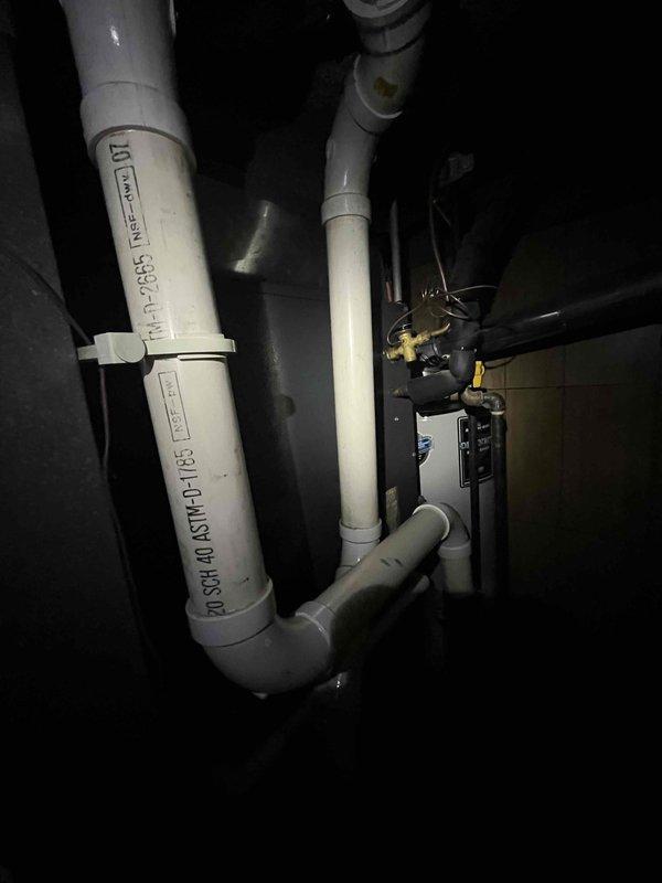 Completed preventive maintenance inspection on club AC12-4 system. Performed visual inspection of condensate drain line assembly and associated plumbing components in mechanical space. Verified PVC drain piping, fittings, and shutoff valves are properly installed and functioning without leaks or blockages. Documented system conditions with photos for maintenance records. All components operating within normal parameters.
