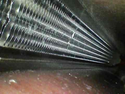 Completed preventive maintenance agreement visit for air conditioning system. Accessed attic-mounted air handler unit, inspected evaporator coil assembly which showed normal operational wear with minor dust accumulation on fins and drain pan. Coil fins intact with proper spacing, refrigerant tubing connections secure. Documented equipment condition with photos showing reflective attic insulation and accessible service area. System components operating within manufacturer specifications at time of inspection.