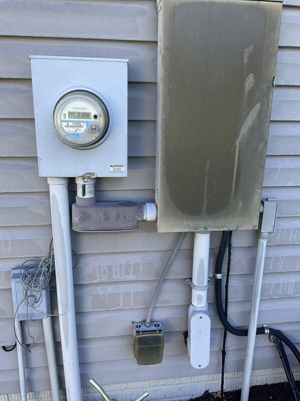 Conducted on-site assessment for new whole home generator installation at manufactured home. Evaluated existing electrical service equipment including digital smart meter, main disconnect panel, and associated conduit routing on exterior wall. Inspected natural gas meter infrastructure and supply lines to confirm adequate fuel source capacity and proper positioning for generator connection.