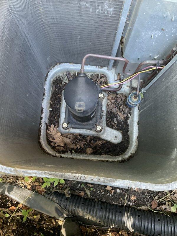 Completed preventative maintenance agreement visit on outdoor HVAC unit. Upon arrival, found exterior casing severely deteriorated with significant damage to lower front section, exposing internal condenser coils, copper refrigerant lines, and electrical components. Unit showed extensive weathering, debris accumulation, and vegetation growth around base and within equipment compartment. Documented current condition with photographs showing compromised protective housing, accumulated organic debris around compressor assembly, and exposed internal components. Unit remains operational but exterior damage poses risk to internal components from environmental exposure and debris infiltration. Recommend replacement of damaged exterior casing and clearance of vegetation and debris to prevent future damage to condenser coils and electrical connections.