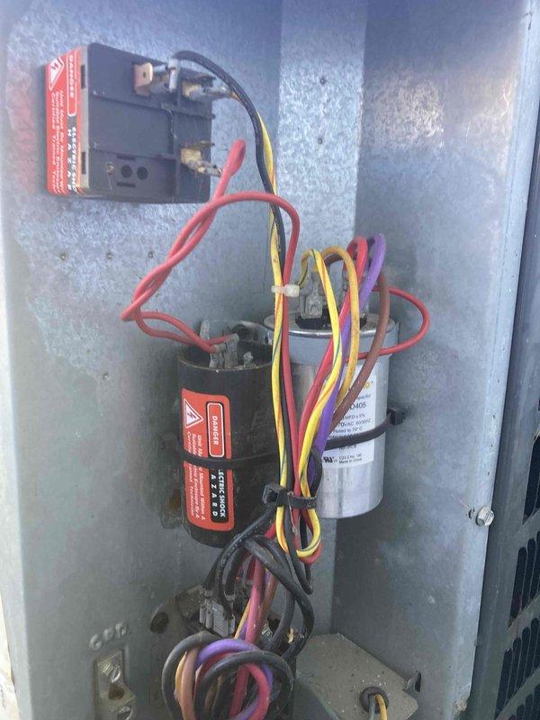 Completed preventive maintenance agreement visit on air conditioning system. Performed comprehensive inspection of electrical components including capacitors, contactors, and associated wiring connections. Documented condition of dual-run capacitor and single capacitor within control compartment, noting terminal connections and overall system operation. All components found operating within normal parameters and system ready for cooling season.