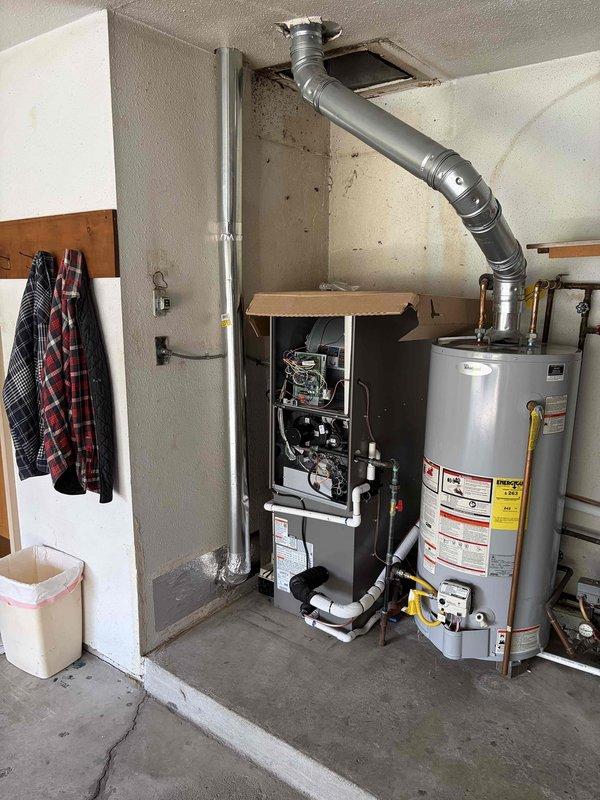 Completed full HVAC system installation including a 70,000 BTU gas furnace and 2.5-ton air conditioning unit. Furnace was wall-mounted in interior mechanical closet with new venting and ductwork connections installed. AC condenser positioned on concrete pad in right side yard with electrical disconnect, conduit, and refrigerant line set properly routed and secured to exterior wall. Installed whole-home humidifier integrated with furnace system. All gas connections, electrical wiring, and condensate drainage completed to code. System tested and verified operational with proper airflow, temperature differential, and safety controls functioning as designed.