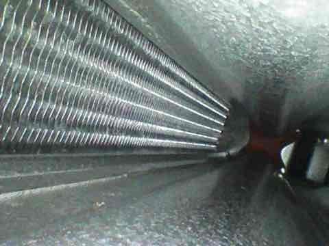 Completed preventive maintenance tune-up on HVAC system. Inspected evaporator coil and heat exchanger components, noting dust accumulation on fins and surfaces. Documented equipment condition through photos for service records.