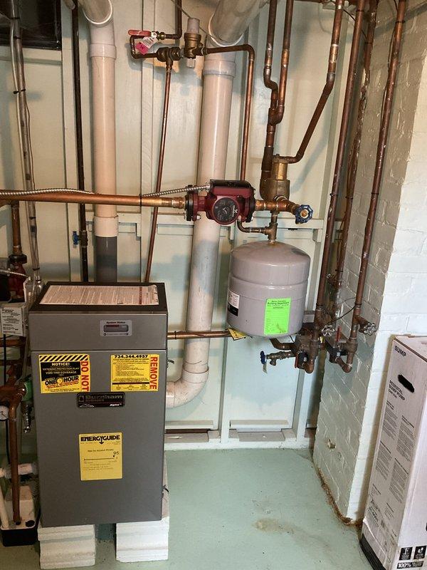 Completed on-site estimate for residential boiler replacement in basement mechanical room. Assessed existing heating system including gray metal boiler unit with extensive copper piping network, red circulator pump, expansion tank, and associated plumbing components. Also evaluated attic-mounted air handler unit with flexible ductwork and condensate drain lines for potential furnace and air conditioning system replacement. Documented current equipment conditions and configurations through detailed photography to provide comprehensive replacement quote for complete HVAC system upgrade.