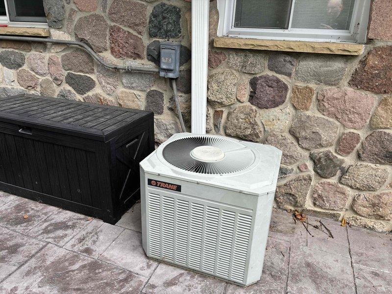 Performed comprehensive HVAC system evaluation on residential split system consisting of Trane outdoor condensing unit and indoor gas furnace. Diagnosed failed heat exchanger in furnace unit, confirmed by visual inspection showing deterioration and safety concerns requiring immediate replacement recommendation. Conducted refrigerant analysis on R22 air conditioning system, identifying undercharged condition with all capacitor readings measuring out of acceptable range, indicating electrical component degradation. Documented equipment conditions through photography for estimate preparation. Provided single component replacement estimate options to address critical heat exchanger failure and discussed full system replacement considerations given age of equipment, obsolete R22 refrigerant, and multiple component deficiencies affecting system reliability and efficiency.
