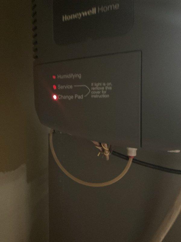 Completed prepaid air conditioning maintenance tune-up on residential HVAC system. Performed comprehensive inspection of outdoor condensing unit and indoor air handler, checking refrigerant lines, electrical connections, and control panel operations. Documented Honeywell Home humidifier with illuminated "Change Pad" service indicator requiring future attention per manufacturer specifications.