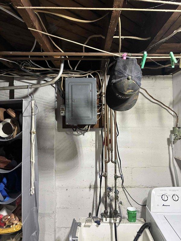 Provided comprehensive estimate for complete AC system replacement. Current outdoor condensers located on covered patio show significant age-related deterioration including rust staining, discoloration, and weathering, with units confirmed non-operational. Assessed existing infrastructure including electrical service panel, basement mechanical room with exposed utilities, and evaluated copper refrigerant line routing between outdoor equipment and basement air handler location for full system replacement specifications.