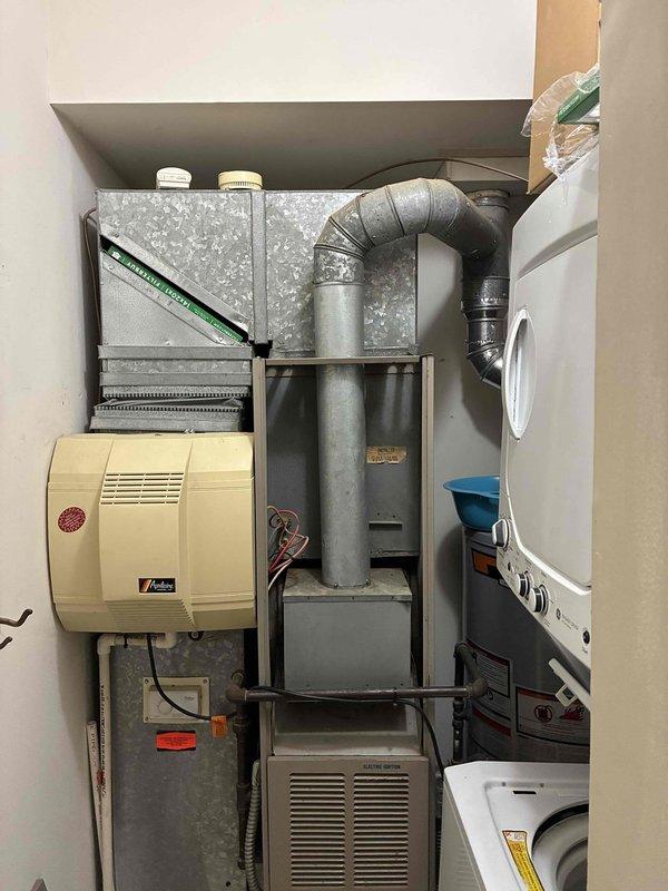 Conducted complimentary estimate for replacement of 20+ year old HVAC system in residential property. Inspected existing furnace unit located in utility closet with humidifier and ductwork configuration, documented equipment condition and layout with photographs, and assessed Nest thermostat for compatibility with replacement system recommendations.