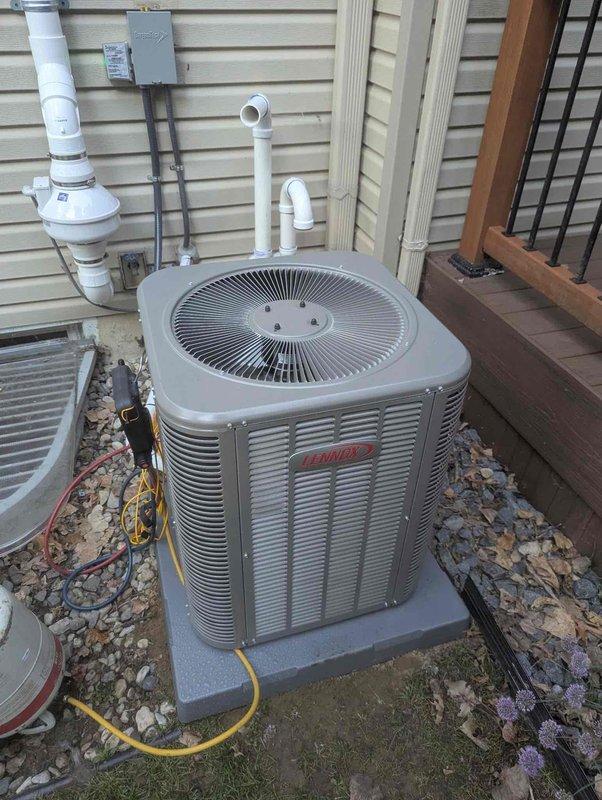 Completed full HVAC system installation including a 70,000 BTU gas furnace and 2-ton air conditioning condenser unit. The furnace was installed in the basement utility area with new white PVC venting routed through the ceiling and proper connection to existing ductwork. The outdoor Bryant condenser unit was positioned on a concrete pad at the rear of the property with appropriate refrigerant line connections, electrical disconnect, and PVC condensate drainage. All mechanical, electrical, and refrigerant connections were completed, system was tested and verified operational upon completion.