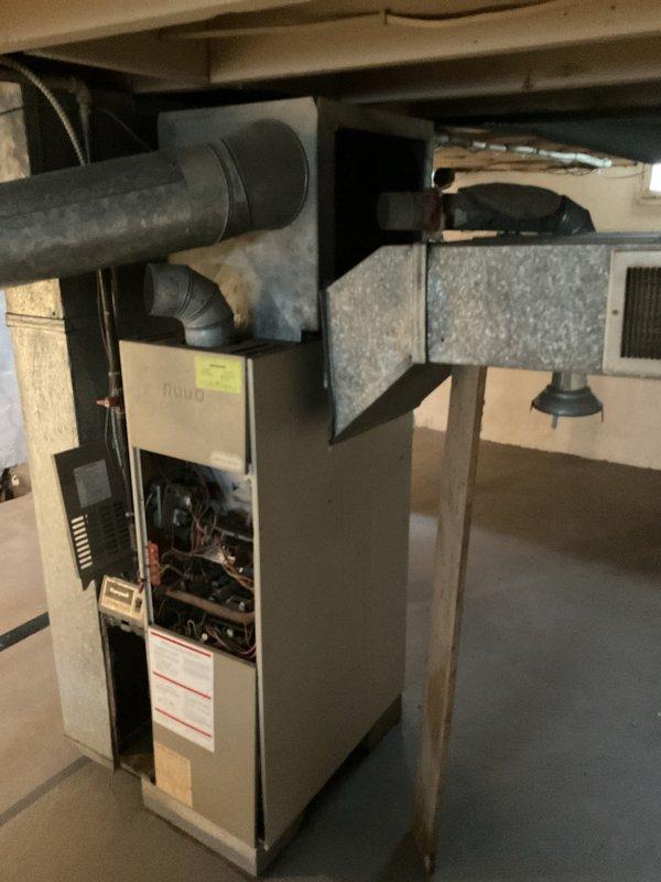 Conducted comprehensive estimate for complete HVAC system replacement, including existing furnace and air conditioning unit, with possible hot water tank replacement. Assessed current equipment condition in basement utility area, documented existing furnace with open service panel to evaluate internal components and wiring, examined ductwork connections and plenum transitions, and photographed metal supply duct system. Provided customer with replacement options and recommendations for new heating and cooling equipment to improve system efficiency and reliability.