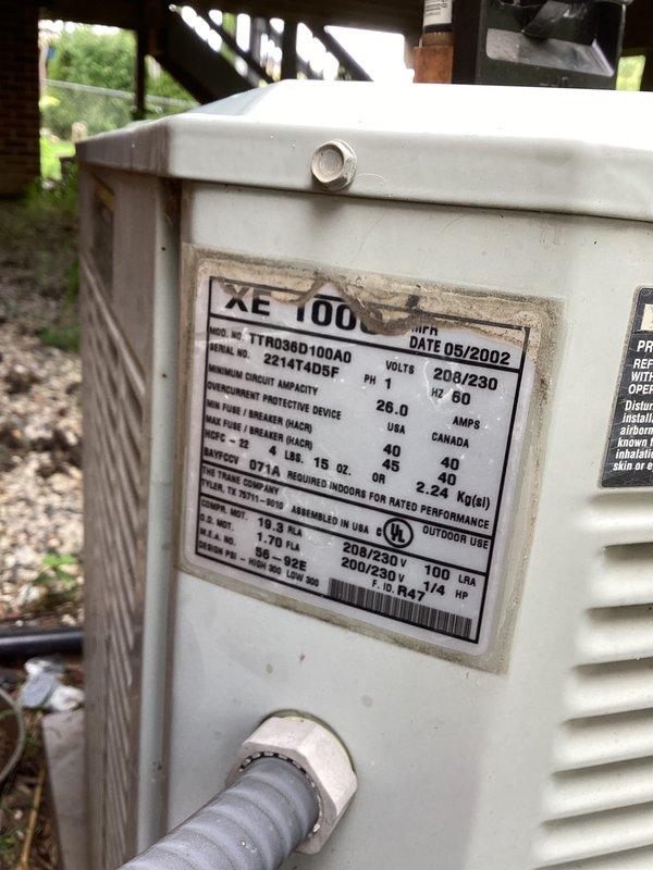 # HVAC Service Completed

Responded to no-cool complaint with reported water leakage from furnace area on 2002 Trane XE 100 condensing unit (Model TTR036D100AD, 208/230V, 60A). Upon inspection, discovered outdoor condensing unit heavily compromised by wildlife intrusion and environmental neglect. Found active bird's nest constructed throughout interior cabinet, with nesting materials intertwined around electrical wiring and refrigerant lines, creating safety hazards and obstructing airflow. 

Unit interior showed extensive debris accumulation, including organic material, dirt, and burnt residue coating bottom surfaces and components. Exterior cabinet exhibited weathering, discoloration, and dirt buildup consistent with extended outdoor exposure without maintenance. Given the unit's age (over 20 years old), compromised condition from wildlife damage, safety concerns with nest material around electrical components, and extensive contamination, advised system replacement rather than repai