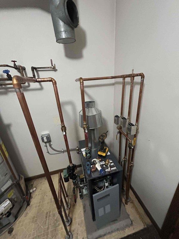 Completed mechanical-only boiler installation in residential utility space. Installed new boiler unit with comprehensive copper piping network, including supply and return lines, expansion tank, ball valves with shutoff capability, and all necessary brass fittings and connections. Reconnected existing electrical components to new system and secured all piping with proper wall brackets to ensure structural integrity and code compliance.