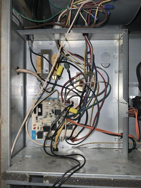 # HVAC Service Call - No Cool Condition

Responded to service call for 20-year-old air conditioning system with no cooling complaint. Upon arrival, performed complete system evaluation of outdoor condensing unit and indoor air handler components.

## Inspection and Findings

Conducted thorough visual inspection of electrical control compartment, revealing aged control circuit board with multiple relays, capacitors, and associated wiring connections. Documented existing wiring configuration showing standard color-coded connections (red, black, white, yellow, blue, green, brown, orange) throughout control box. Noted presence of transformers and relay components within electrical enclosure.

Inspected indoor air handler unit located in utility closet adjacent to kitchen area. Examined furnace/air handler cabinet with louvered door panels designed for proper air circulation. Verified ductwork connections including both flexible and rigid metal sections.

## System Assessment

Given the adv