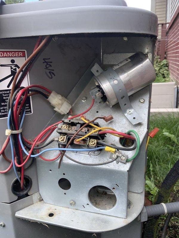 Responded to service call for 15-year-old AC unit running continuously without reaching set temperature and intermittently tripping breaker. Upon arrival, performed comprehensive system diagnostic including electrical component inspection and blower assembly evaluation. Accessed exterior condensing unit electrical compartment and documented internal wiring connections, capacitor, and contactor condition. Inspected blower wheel assembly for debris accumulation and proper operation. Given the unit's age and presenting symptoms of continuous operation with inadequate cooling, identified multiple potential failure points including worn electrical components, possible refrigerant issues, or compressor degradation typical of systems exceeding manufacturer's expected service life. Photographed electrical connections and blower assembly for documentation purposes. Advised customer of diagnostic findings and recommended evaluation of repair costs versus replacement options, considering the unit