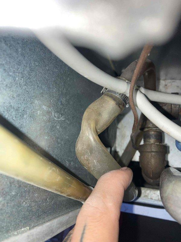 Completed preventive maintenance tune-up on gas furnace system. Inspected gas valve assembly, verified proper electrical connections and wiring integrity, and examined condensate drain piping and fittings for signs of corrosion or leakage. All components found to be operating within normal parameters with typical aging present on metallic surfaces.