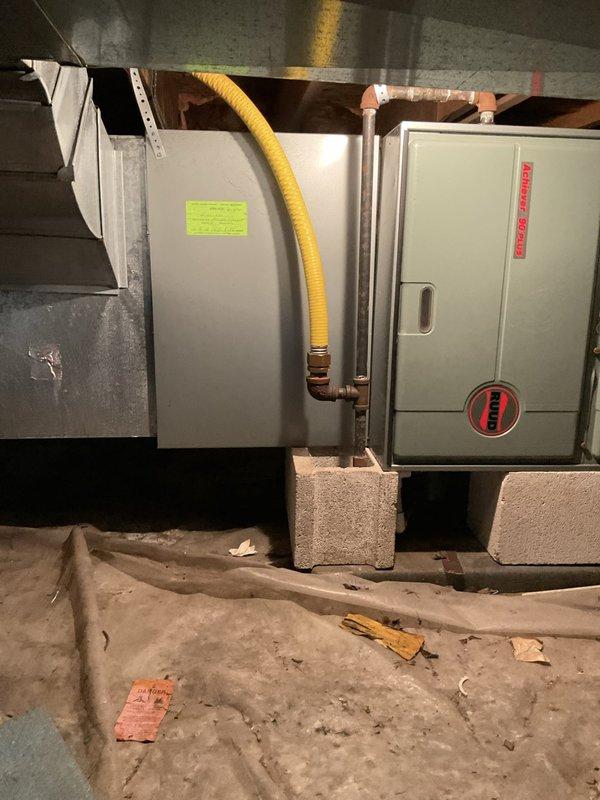 Conducted comprehensive assessment of 30-year-old HVAC system located in basement for equipment replacement estimate. Evaluated existing Rheem air handler unit and associated ductwork, noting current system remains operational but has reached end of expected service life. Documented equipment specifications, installation configuration including concrete block mounting, metal ductwork connections, copper refrigerant lines with flexible ducting, and overall system layout to provide accurate replacement recommendations for complete system upgrade.
