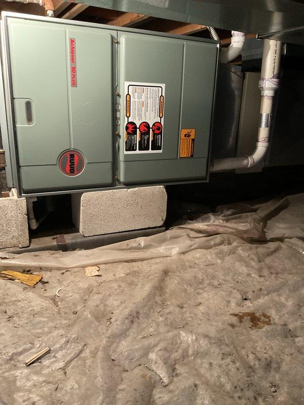 Conducted comprehensive assessment of 30-year-old HVAC system located in basement for equipment replacement estimate. Evaluated existing Rheem air handler unit and associated ductwork, noting current system remains operational but has reached end of expected service life. Documented equipment specifications, installation configuration including concrete block mounting, metal ductwork connections, copper refrigerant lines with flexible ducting, and overall system layout to provide accurate replacement recommendations for complete system upgrade.