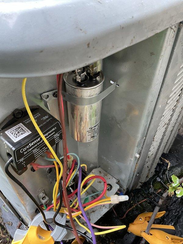 Performed Club AC preventative maintenance agreement visit on residential air conditioning system. Conducted comprehensive inspection of outdoor condensing unit, verifying proper leveling of equipment pad and checking all electrical components including capacitor and CoreSense monitoring device. Cleaned unit interior, inspected all wire connections and terminals, and documented system condition with photographic records for maintenance history.