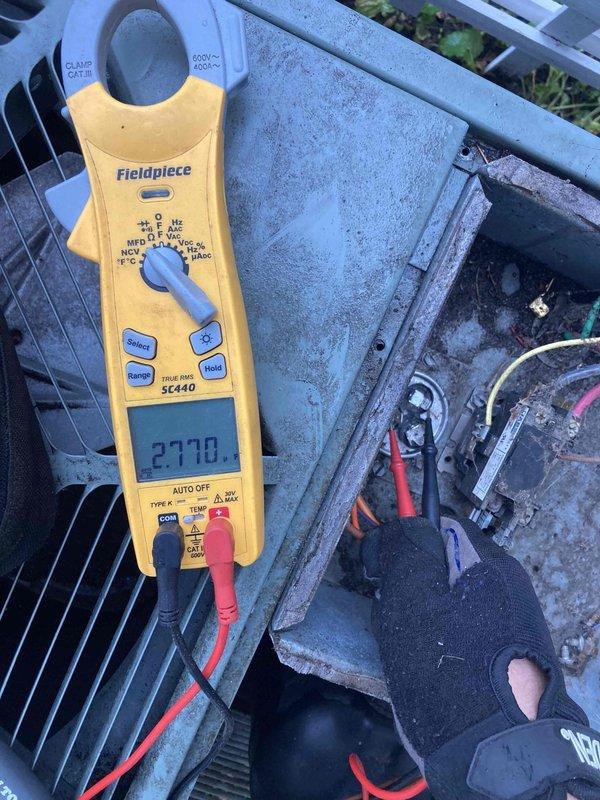 Completed Club AC10-2 preventive maintenance agreement visit on residential air conditioning system. Performed comprehensive electrical diagnostics using clamp meter, recording amperage reading of 27.70 amps on outdoor condensing unit. Inspected all electrical connections, wiring, and components for proper operation. Documented existing condition of refrigerant line insulation showing deterioration and discoloration on suction line. System operating within normal parameters at time of inspection.