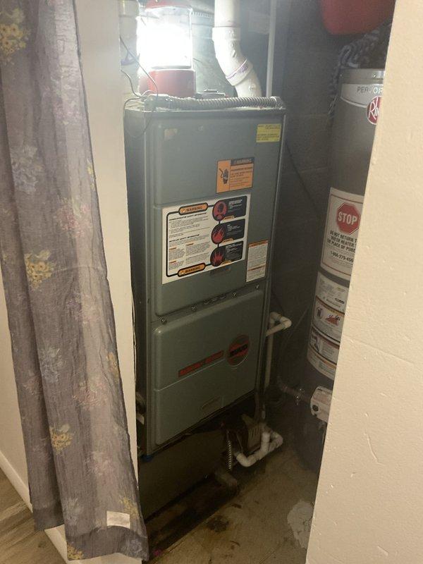 Conducted comprehensive system evaluation of 20+ year old R-22 residential HVAC system exhibiting heavy damages in basement installation. Assessed furnace unit, ductwork connections, and condensate drainage system to determine replacement requirements. Documented equipment condition through photographic evidence showing deteriorated components, floor staining indicating potential drainage issues, and aging infrastructure requiring full system replacement estimate due to obsolete refrigerant type and extensive wear beyond economical repair.