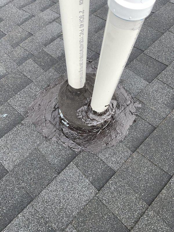 Responded to water intrusion complaint originating from ceiling. Upon inspection, identified compromised roof flashing and sealing around plumbing vent stacks penetrating through asphalt shingle roof surface. Documented condition of PVC DWV pipes and surrounding tar/roofing cement flashing showing signs of deterioration that allowed water entry during precipitation events. Verified HVAC unit levelness and operational status as part of routine maintenance agreement visit.