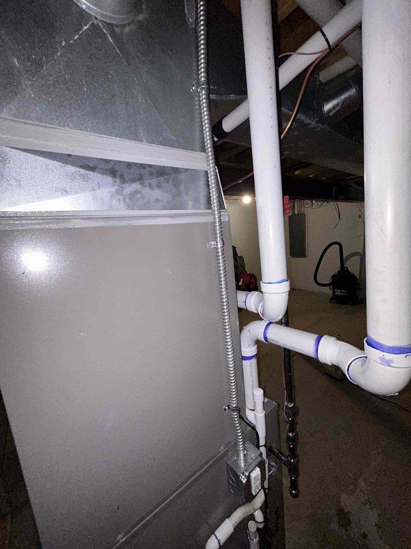 Completed full HVAC system installation in basement utility area including 90,000 BTU gas furnace and 3.5 ton air conditioning unit. Performed all mechanical and electrical connections per manufacturer specifications and local code requirements. Installed new PVC condensate drain piping with proper pitch and trap configuration. Routed flexible ductwork through ceiling joists and connected to new equipment. Ran electrical conduit and wiring to power units. Reconnected all system components and verified proper operation of heating and cooling functions. All equipment tested and operational upon completion.