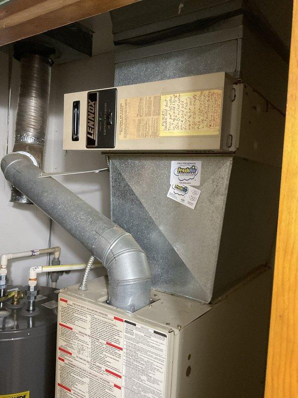 Completed estimate for central air conditioning system installation at property currently equipped with gas furnace and Lennox electronic air cleaner but lacking air conditioning. Assessed existing HVAC infrastructure including furnace unit, metal plenum, ductwork configuration, and available mechanical room space to determine optimal AC system integration. Evaluated exterior installation location near building foundation with consideration for landscaping and siding clearance requirements. Provided comprehensive replacement estimate covering new AC condenser unit, refrigerant line set, condensate drain, electrical connections, thermostat upgrade, and integration with existing forced air system.