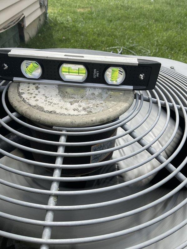 Responded to report of major water leak inside two-year-old furnace unit. Upon arrival, inspected indoor furnace assembly and confirmed system was operational despite water intrusion. Examined blower housing, heat exchanger fins, and internal components to identify source of water accumulation not originating from water line. Inspected outdoor condensing unit and verified levelness of equipment pad, noting unit was not properly leveled which can contribute to drainage issues. Documented equipment condition with photos showing internal furnace components and outdoor unit positioning. System requires follow-up service to address water leak source and proper leveling of outdoor unit to ensure adequate condensate drainage.