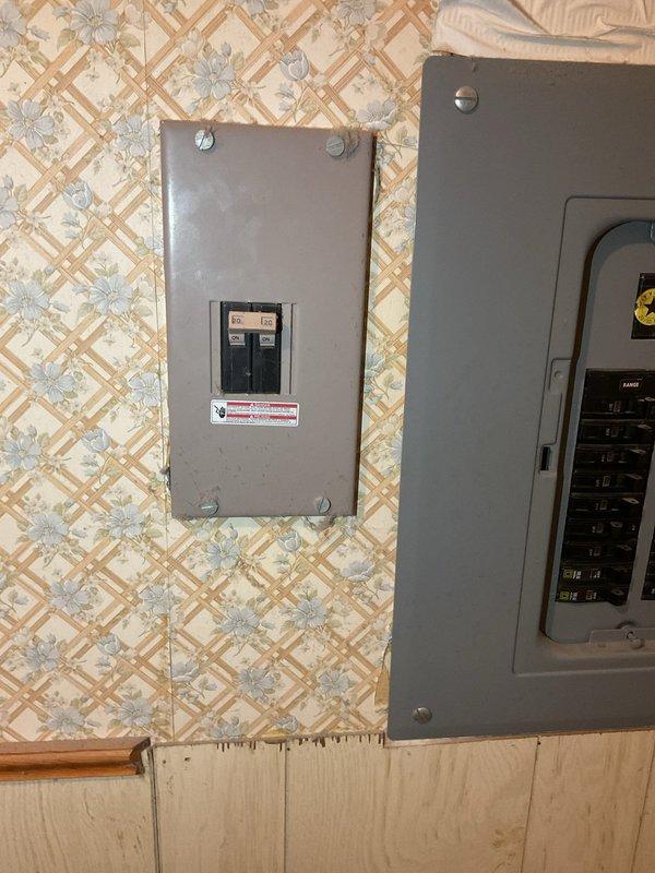 Completed electrical estimate for new whole home generator installation at manufactured home. Assessed existing electrical panel configuration and available space for generator placement. Documented current electrical infrastructure including main panel and sub-panel to determine integration requirements for automatic transfer switch and generator connection.