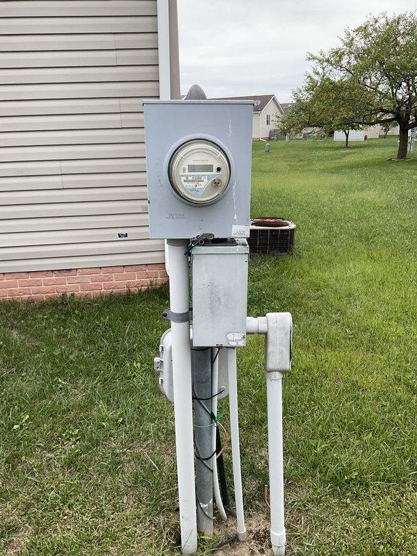Completed estimate for air conditioning system replacement due to existing unit requiring multiple repairs and being low on R22 refrigerant. Assessed indoor air handler installation in wall cavity with existing ductwork and electrical connections, and evaluated outdoor electrical service configuration at meter location. Documented current system conditions and provided replacement options for new equipment installation.