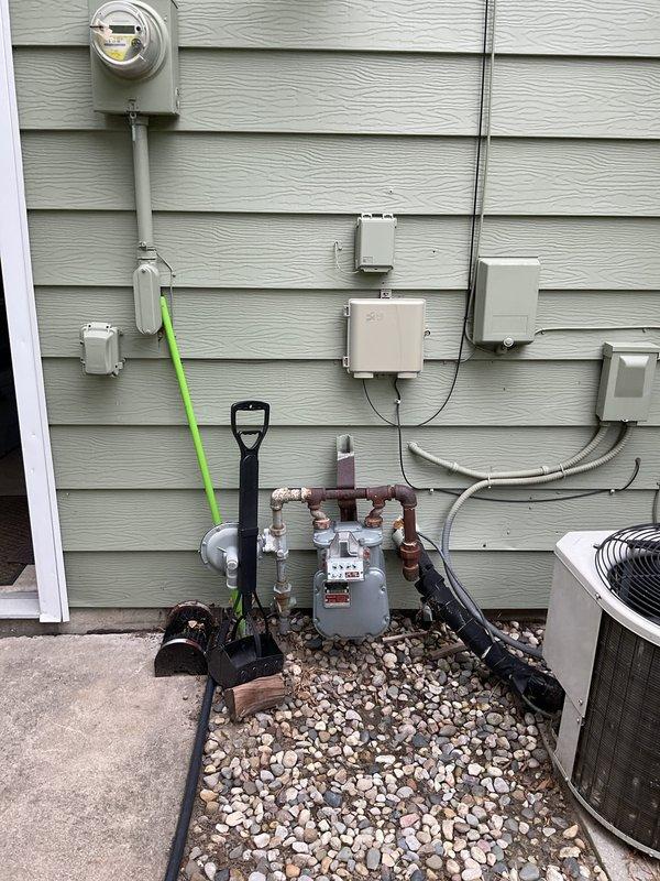 Conducted comprehensive site assessment for HVAC system replacement estimate on 23-year-old residential heating and cooling equipment. Evaluated existing exterior utility infrastructure including electrical service, gas meter assembly, and current condensing unit configuration to determine replacement requirements and compatibility with existing connections. Documented electrical disconnect box, conduit routing, gas line manifold system, and available clearances for new equipment installation to provide accurate replacement specifications and identify any necessary modifications to existing utility connections.