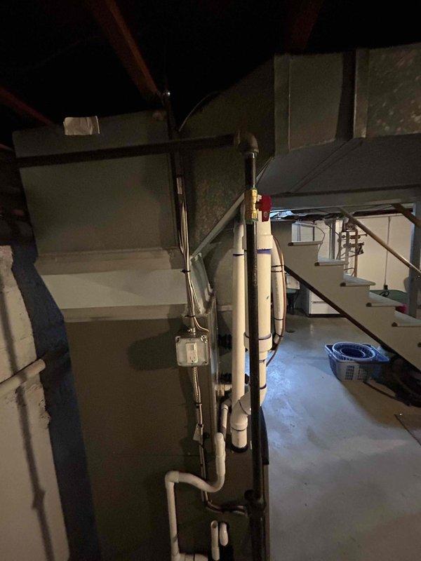 # HVAC System Installation

Completed full mechanical installation of a 70,000 BTU gas furnace and 2.5-ton air conditioning system in basement utility area. Positioned equipment in rear configuration per specifications. Installed all necessary refrigerant lines, condensate drainage, gas piping, and electrical connections. Ran PVC condensate drain lines with proper pitch and fittings to floor drain. Mounted disconnect switches and completed all electrical wiring to code. Connected supply and return ductwork to new furnace unit. Performed reconnection of existing ductwork infrastructure to integrate with new equipment. Verified all pipe joints, fittings, and electrical terminations for proper installation. System positioned against wall with adequate clearance for service access. All mechanical components secured and operational. Installation completed per mechanical-only scope, ready for startup and commissioning upon final approval.
