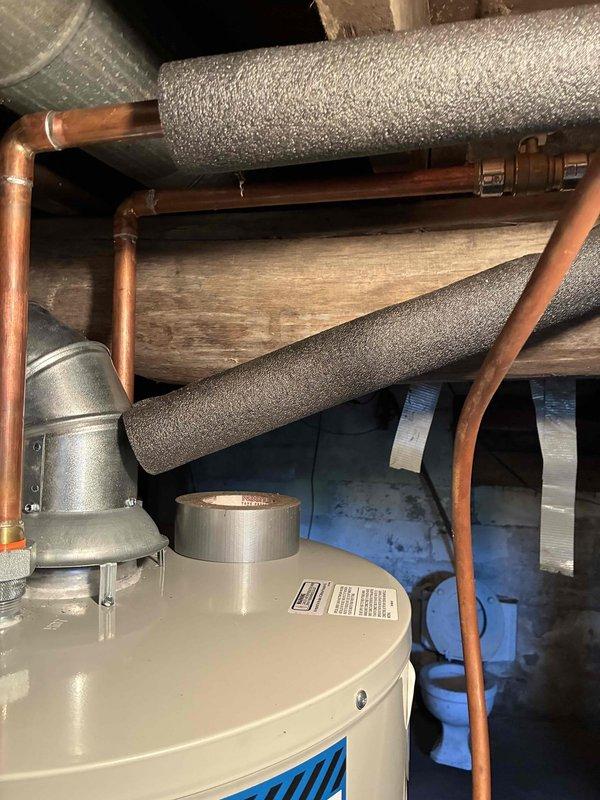 Installed a new 40-gallon liquid propane water heater in the crawl space utility area. Connected copper supply lines and integrated the unit with existing HVAC ductwork, ensuring all plumbing connections were properly secured and tested for leaks. Installation completed with all components functioning to manufacturer specifications.