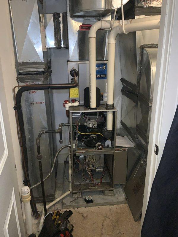 Completed city inspection on HVAC system and air handler unit located in mechanical room. Performed visual inspection of all equipment, including furnace, condensate drainage system, refrigerant lines, and electrical connections. Verified proper operation of blower motor and internal components with access panel opened for thorough examination. Inspected PVC condensate lines, trap assembly, and drainage routing for proper installation and flow. Checked refrigerant line insulation and electrical conduit connections along wall-mounted piping. Documented equipment condition and installation with photographs for inspection records. All components found operational and meeting code requirements for city inspection approval.
