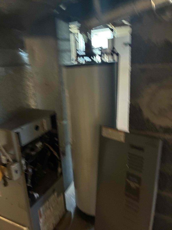 Conducted on-site evaluation of existing HVAC system and water heating equipment in residential mechanical room. Assessed current boiler unit, cylindrical water heater tank, and associated ductwork configuration. Documented equipment conditions through photographic inspection, noting existing PVC/metal ductwork routing, mechanical connections, and piping infrastructure. Provided comprehensive replacement estimate for single HVAC component based on observed system layout and mechanical specifications.