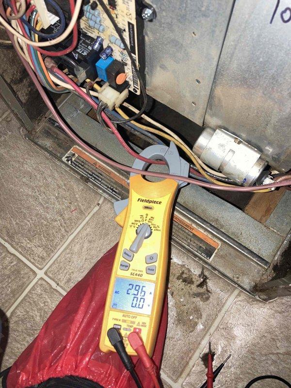 Completed scheduled HVAC maintenance tune-up on air conditioning and air handler system as part of membership agreement benefits. Performed comprehensive system inspection, electrical diagnostics with multimeter showing 295V supply, verified blower motor operation, and assessed internal components including capacitor and control board functionality. Noted significant dust accumulation on blower motor assembly and surrounding cabinet areas with visible paint deterioration on motor housing; system operating within normal parameters with no immediate repairs required at time of service.