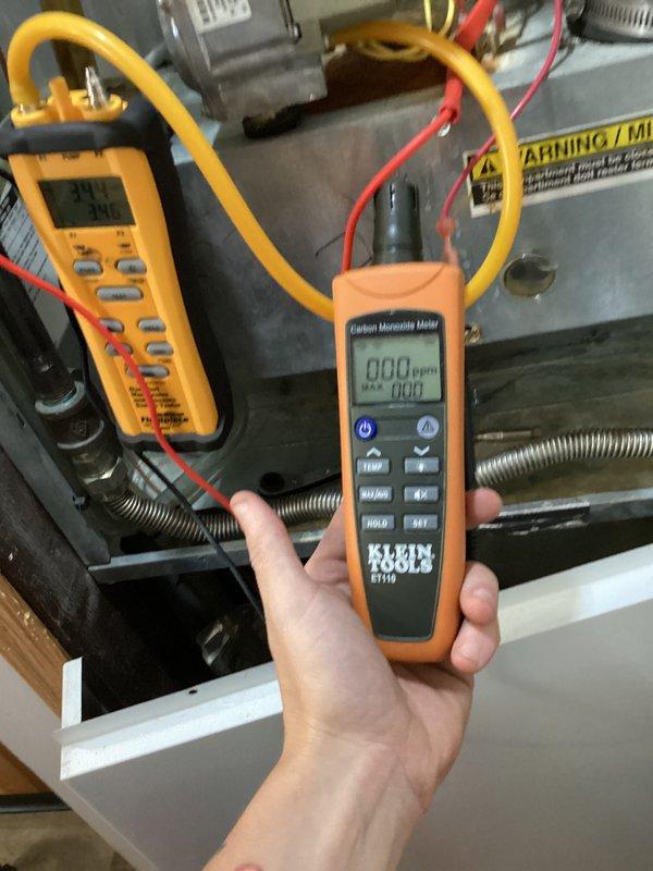 Performed preventive maintenance inspection on heating system under club membership agreement. Conducted comprehensive safety testing including carbon monoxide level verification, which registered 0.00 PPM indicating proper combustion and venting operation. Measured and documented electrical performance using digital multimeter, recording 2.0 DC voltage at capacitor terminals to verify proper component operation. All system components inspected and found operating within manufacturer specifications with no immediate service needs identified.