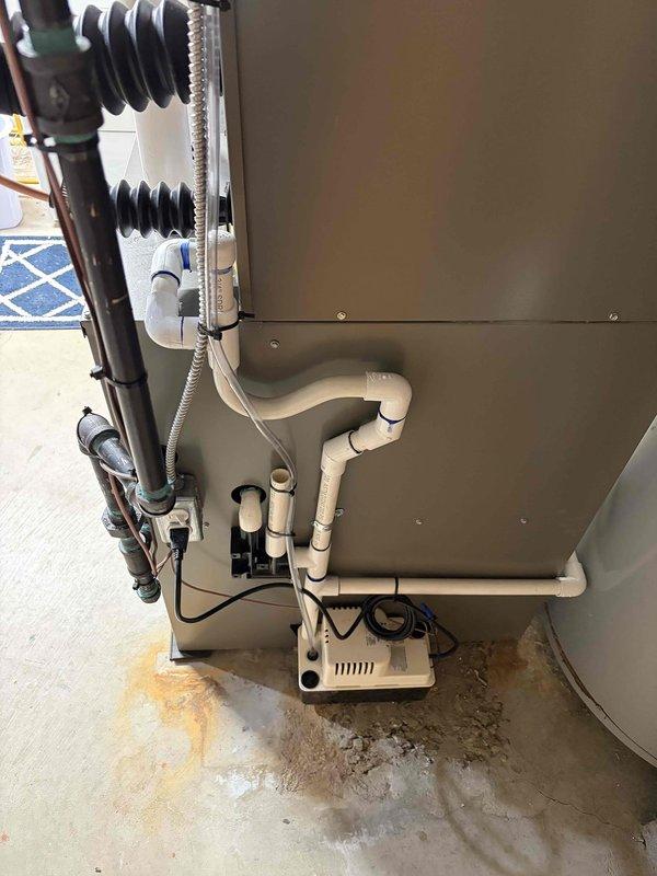 Completed full HVAC system installation in residential basement, including new Lennox furnace and air conditioning unit with air handler. Installed white PVC venting pipes for exhaust and intake, connected metal ductwork, and established condensate drainage system with pump at equipment base. System secured through Michigan Saves financing program, with all required documentation and identification collected and processed via electronic signature platform.