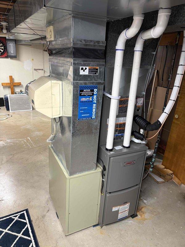 Completed full HVAC system installation in residential basement, including new Lennox furnace and air conditioning unit with air handler. Installed white PVC venting pipes for exhaust and intake, connected metal ductwork, and established condensate drainage system with pump at equipment base. System secured through Michigan Saves financing program, with all required documentation and identification collected and processed via electronic signature platform.